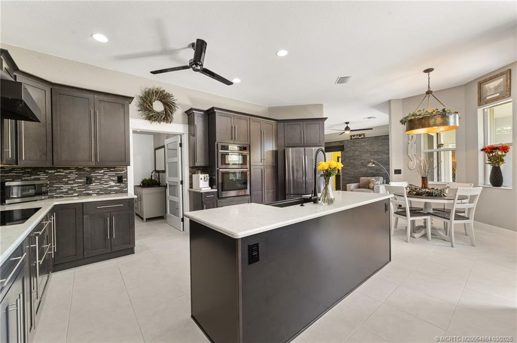2072 Southeast Hanford Road Port St. Lucie, FL 34952 - Photo 19 of 58 a large kitchen with a large counter top appliances and cabinets