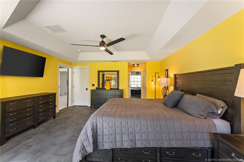 2072 Southeast Hanford Road Port St. Lucie, FL 34952 - Photo 25 of 58 a bedroom with a bed and a flat screen tv