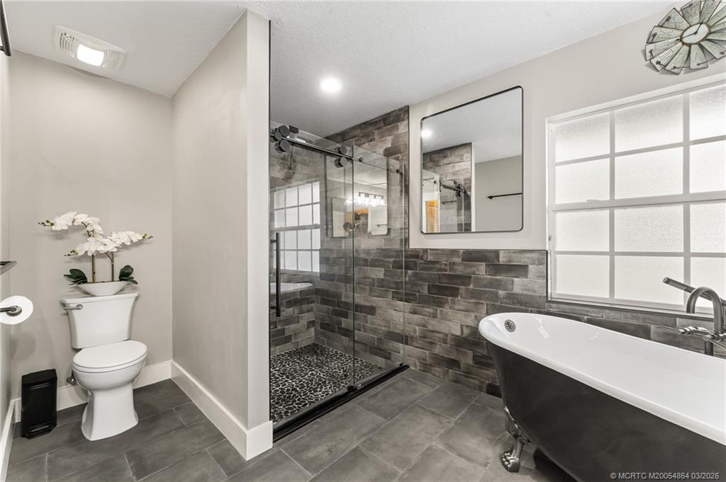 2072 Southeast Hanford Road Port St. Lucie, FL 34952 - Photo 27 of 58 a bathroom with a sink toilet and shower