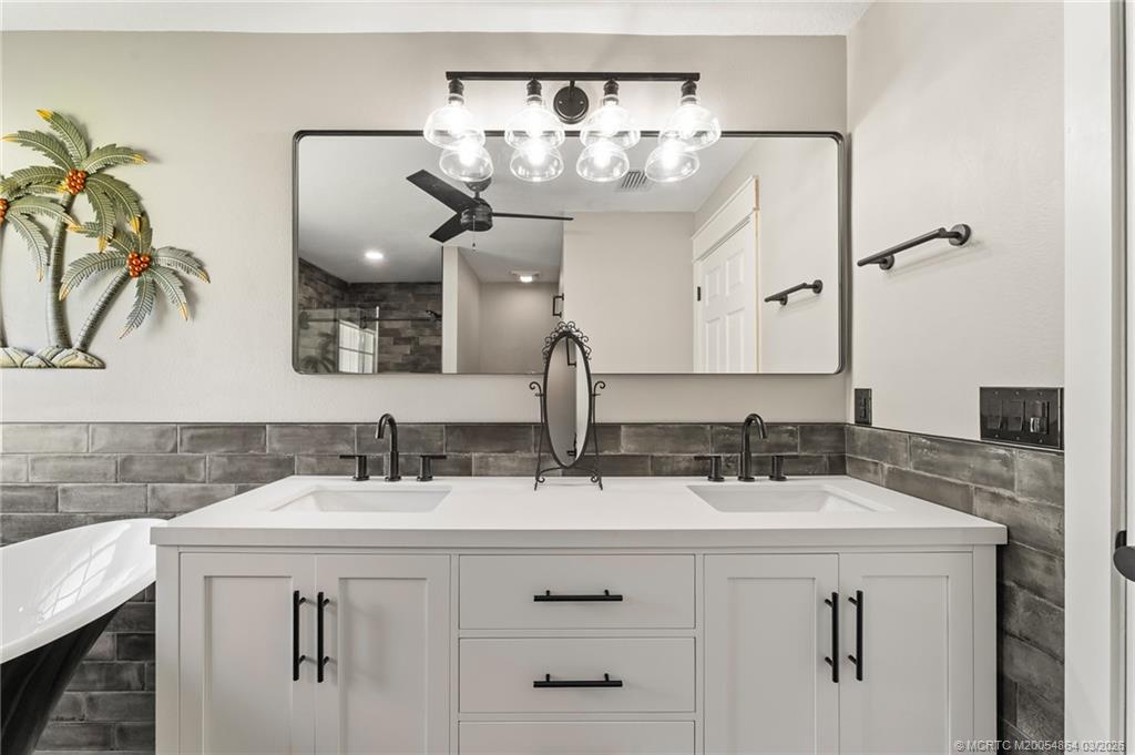 2072 Southeast Hanford Road Port St. Lucie, FL 34952 - Photo 29 of 58 a bathroom with a double vanity sink and a mirror