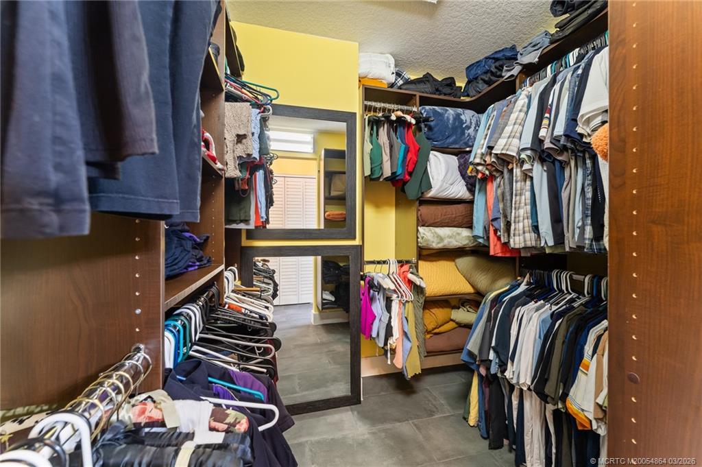 2072 Southeast Hanford Road Port St. Lucie, FL 34952 - Photo 30 of 58 a view of walk in closet with clothes and shoes
