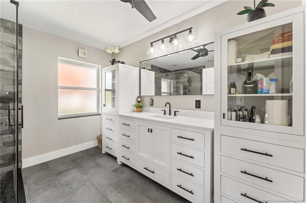 2072 Southeast Hanford Road Port St. Lucie, FL 34952 - Photo 36 of 58 a bathroom with double vanity and a window