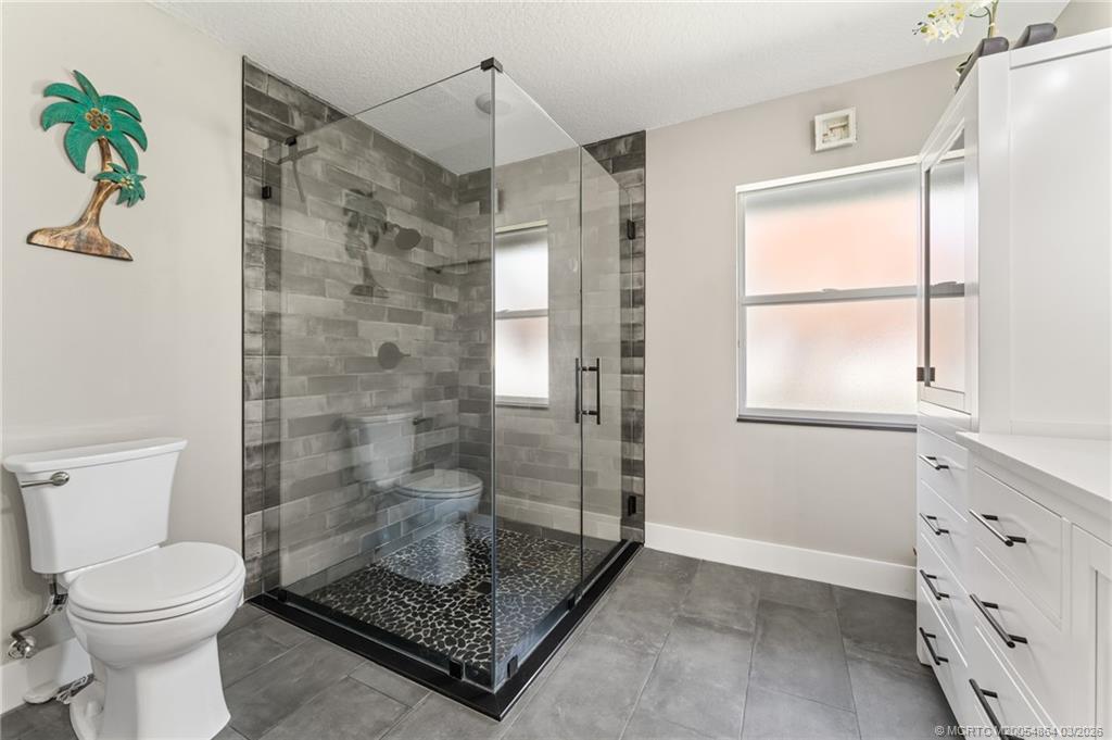 2072 Southeast Hanford Road Port St. Lucie, FL 34952 - Photo 38 of 58 a bathroom with a shower and a toilet
