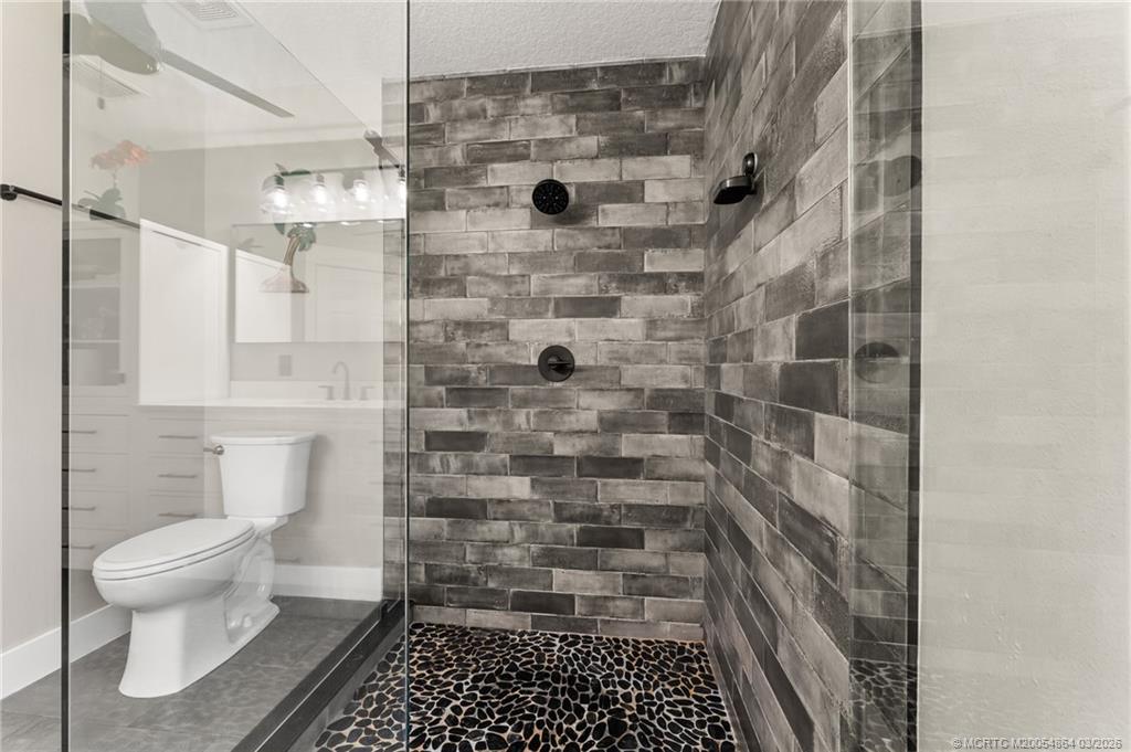 2072 Southeast Hanford Road Port St. Lucie, FL 34952 - Photo 39 of 58 a bathroom with a toilet and a shower