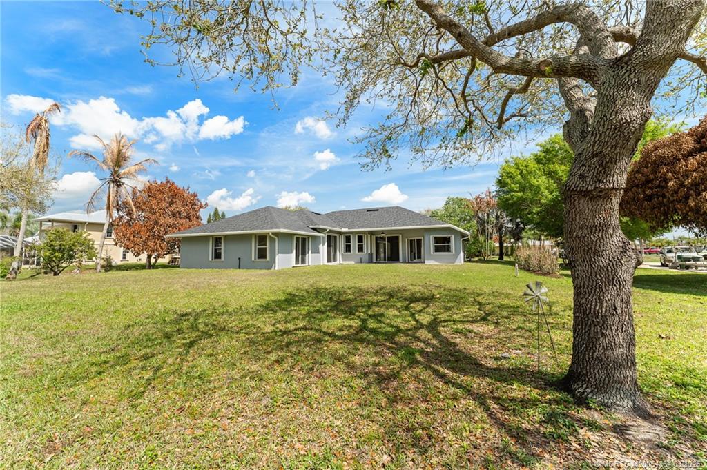 2072 Southeast Hanford Road Port St. Lucie, FL 34952 - Photo 48 of 58 a front view of a house with a garden