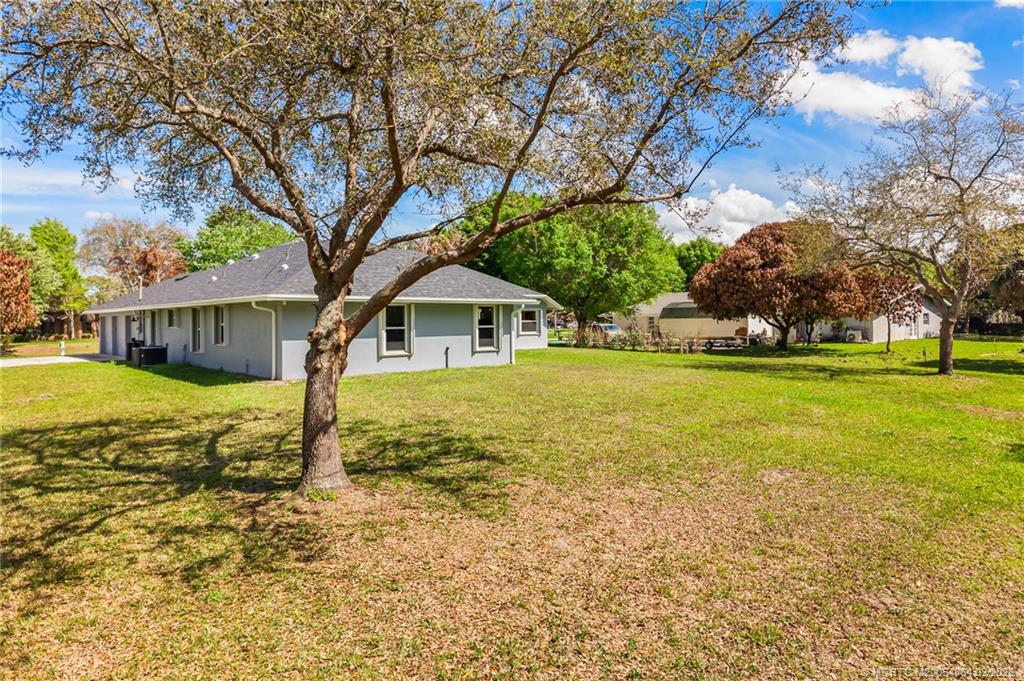 2072 Southeast Hanford Road Port St. Lucie, FL 34952 - Photo 49 of 58 a front view of house with yard and green space