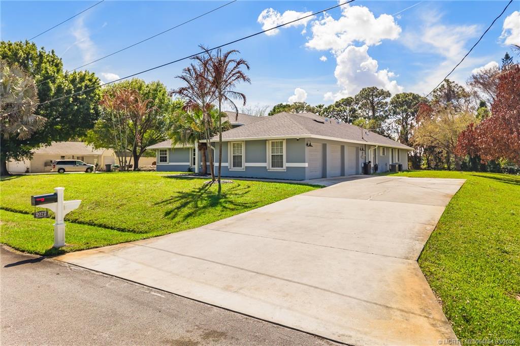 2072 Southeast Hanford Road Port St. Lucie, FL 34952 - Photo 54 of 58 a view of a house with a yard and tree s