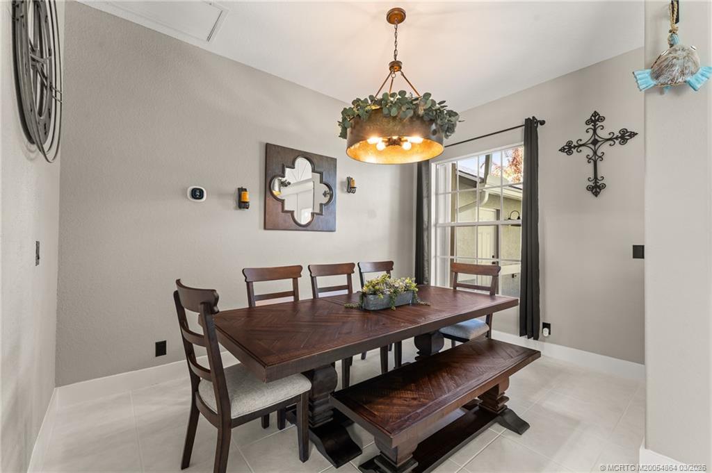 2072 Southeast Hanford Road Port St. Lucie, FL 34952 - Photo 9 of 58 a view of a dining room with furniture window and chandelier