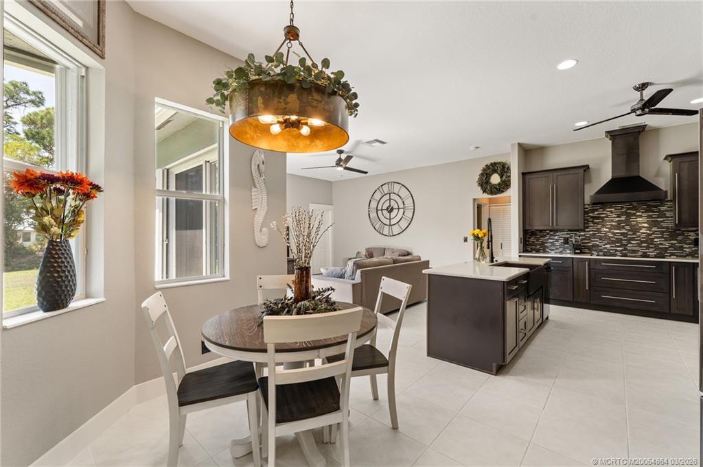 2072 Southeast Hanford Road Port St. Lucie, FL 34952 - Photo 10 of 58 a view of a dining room with furniture and chandelier