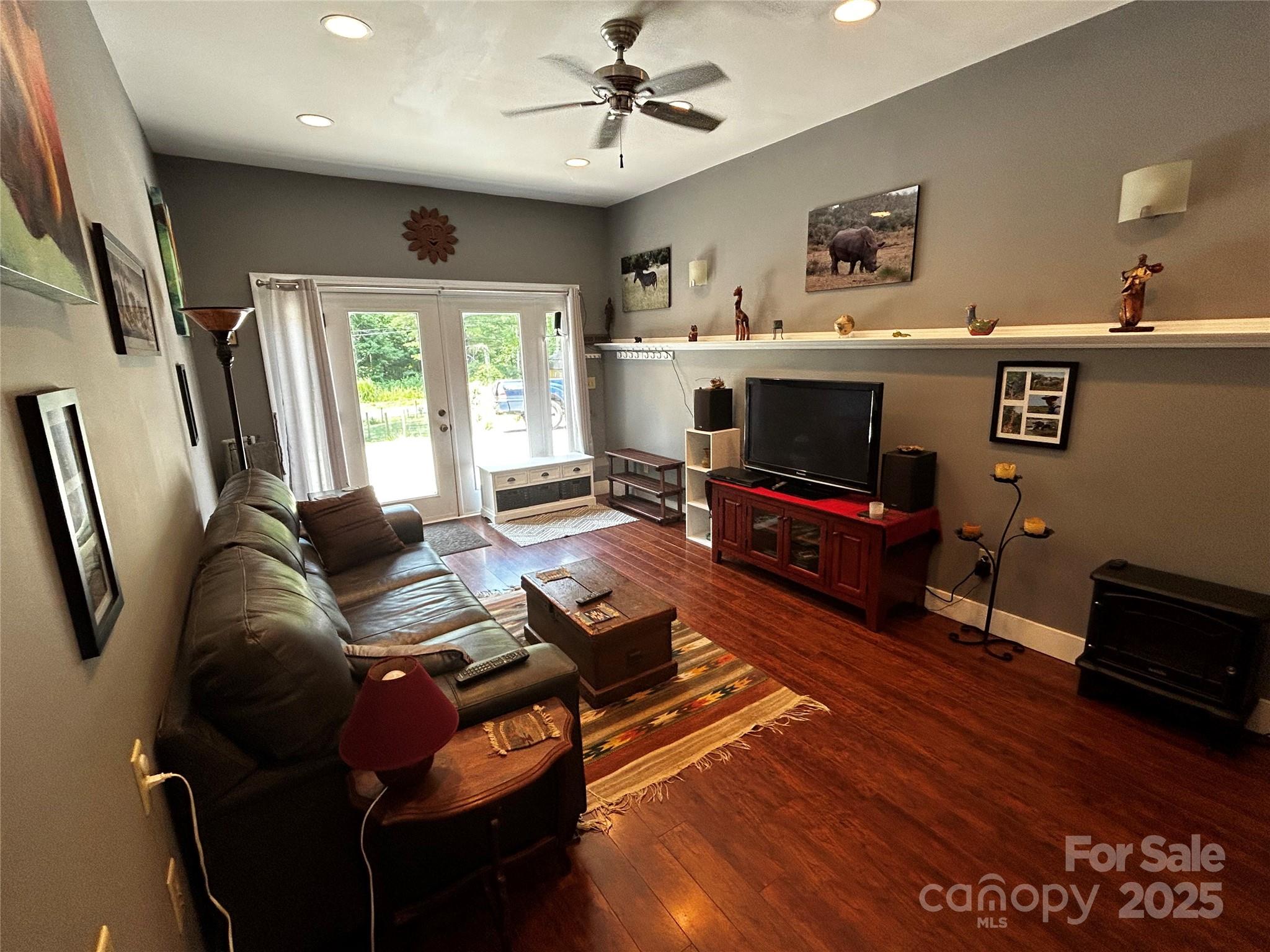 283 Bull Creek Road Asheville, NC 28805 - Photo 12 of 35 a living room with furniture and a flat screen tv
