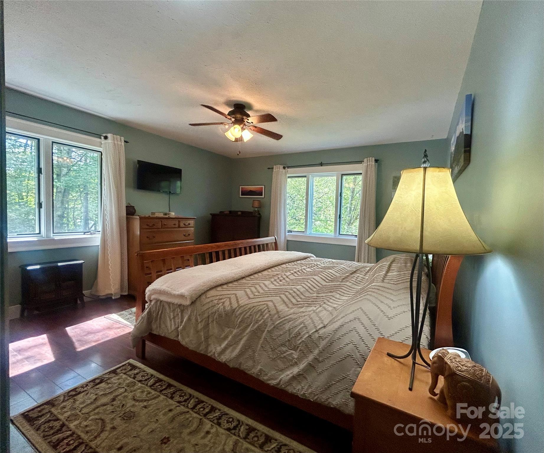 283 Bull Creek Road Asheville, NC 28805 - Photo 16 of 35 a bedroom with a bed and a chandelier