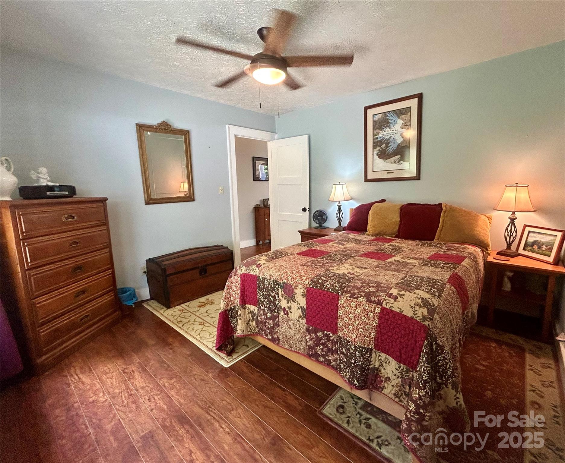 283 Bull Creek Road Asheville, NC 28805 - Photo 21 of 35 a bedroom with a bed and a chandelier