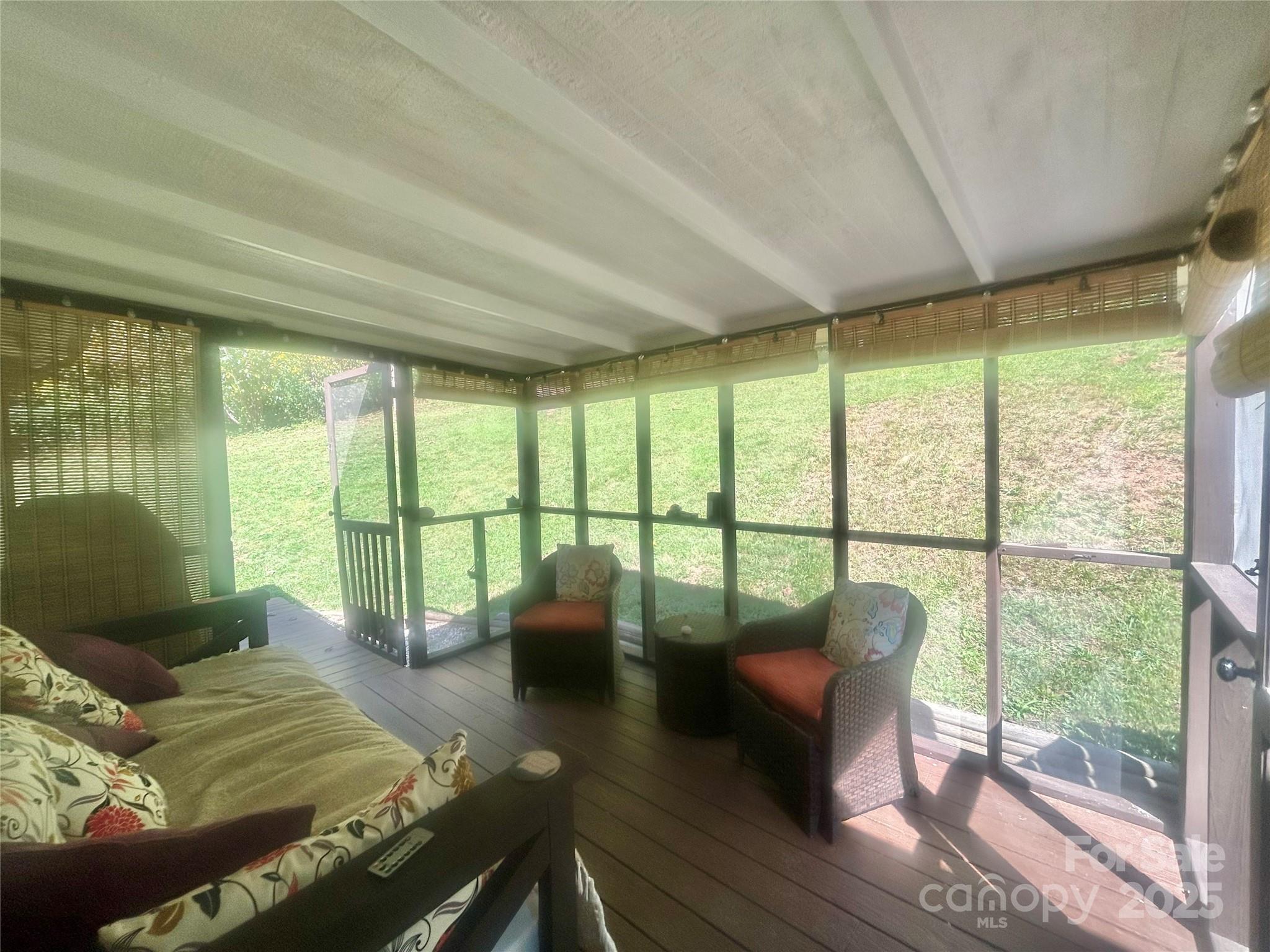 283 Bull Creek Road Asheville, NC 28805 - Photo 24 of 35 a bedroom with furniture and large windows