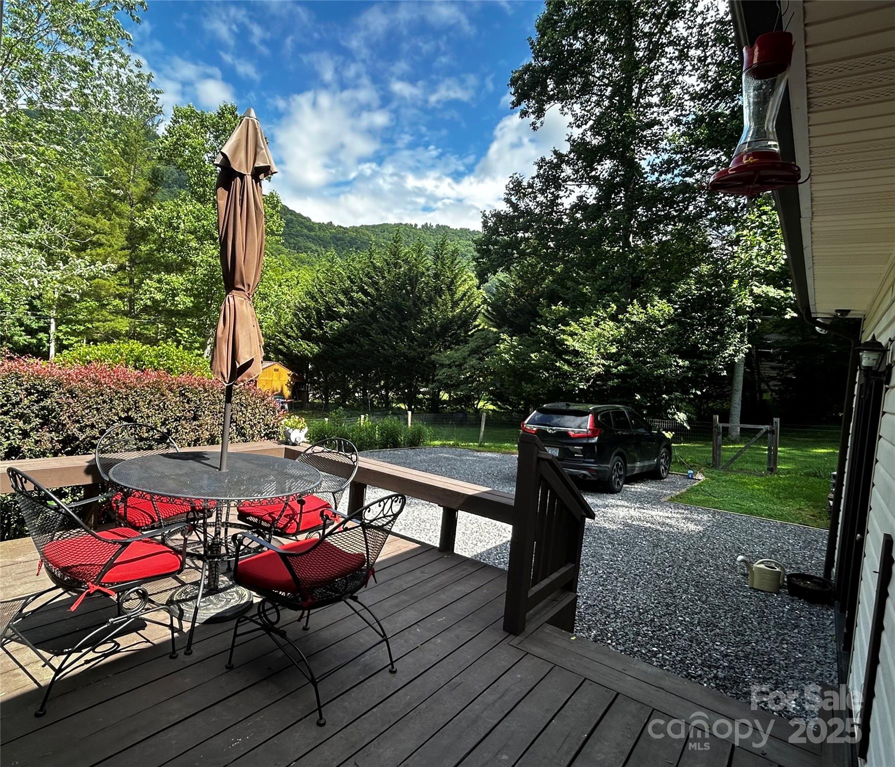 283 Bull Creek Road Asheville, NC 28805 - Photo 27 of 35 a view of a roof deck with table and chairs and wooden floor