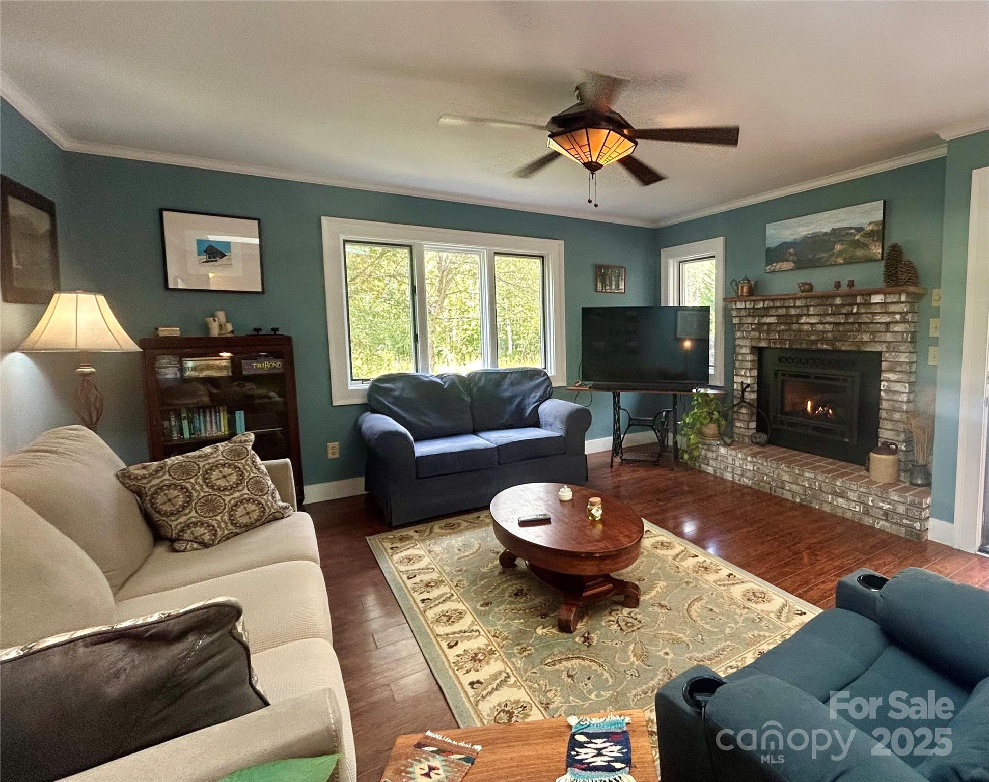 283 Bull Creek Road Asheville, NC 28805 - Photo 3 of 35 a living room with furniture and a fireplace