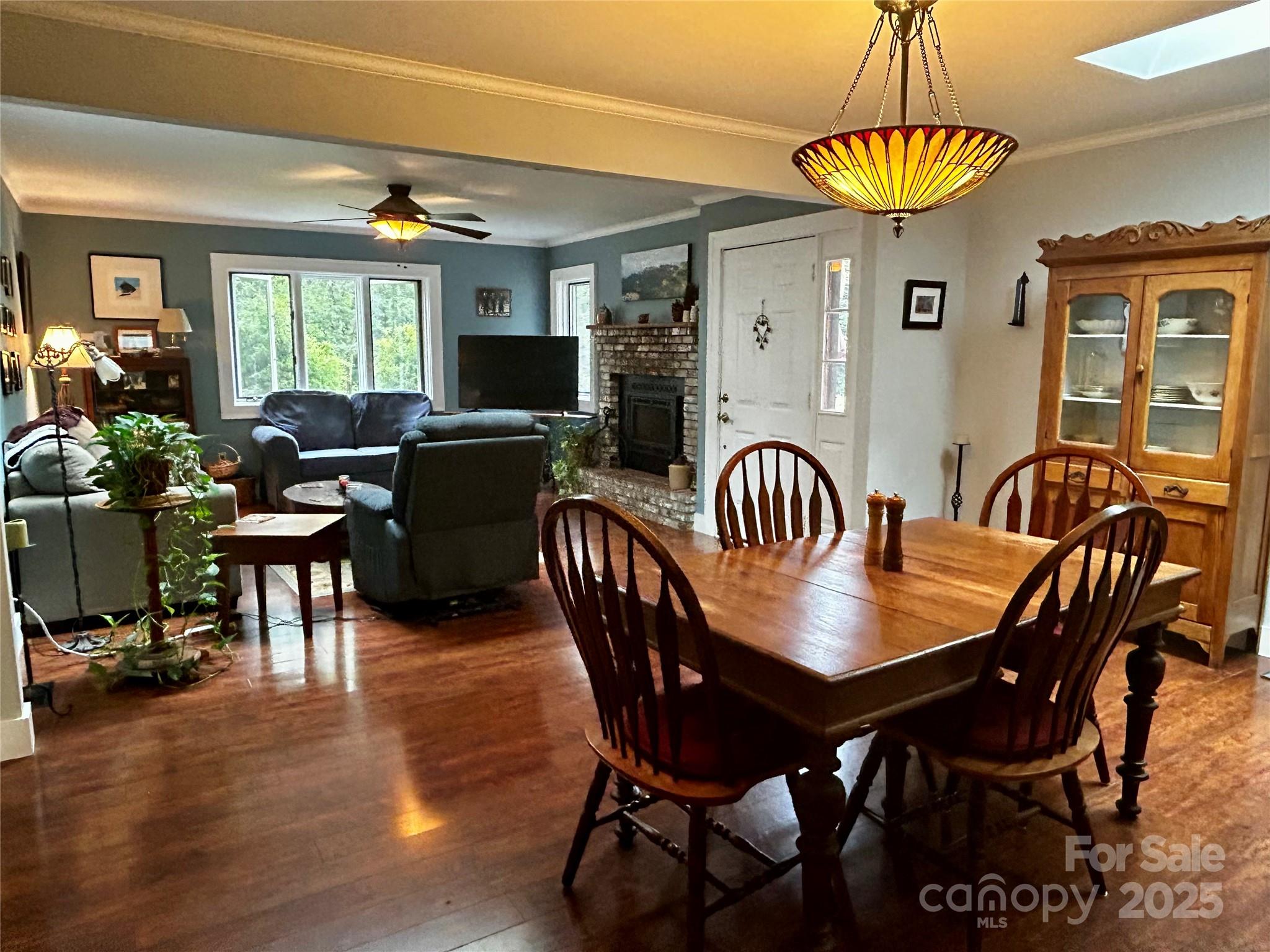 283 Bull Creek Road Asheville, NC 28805 - Photo 6 of 35 a view of a dining room with furniture window and wooden floor