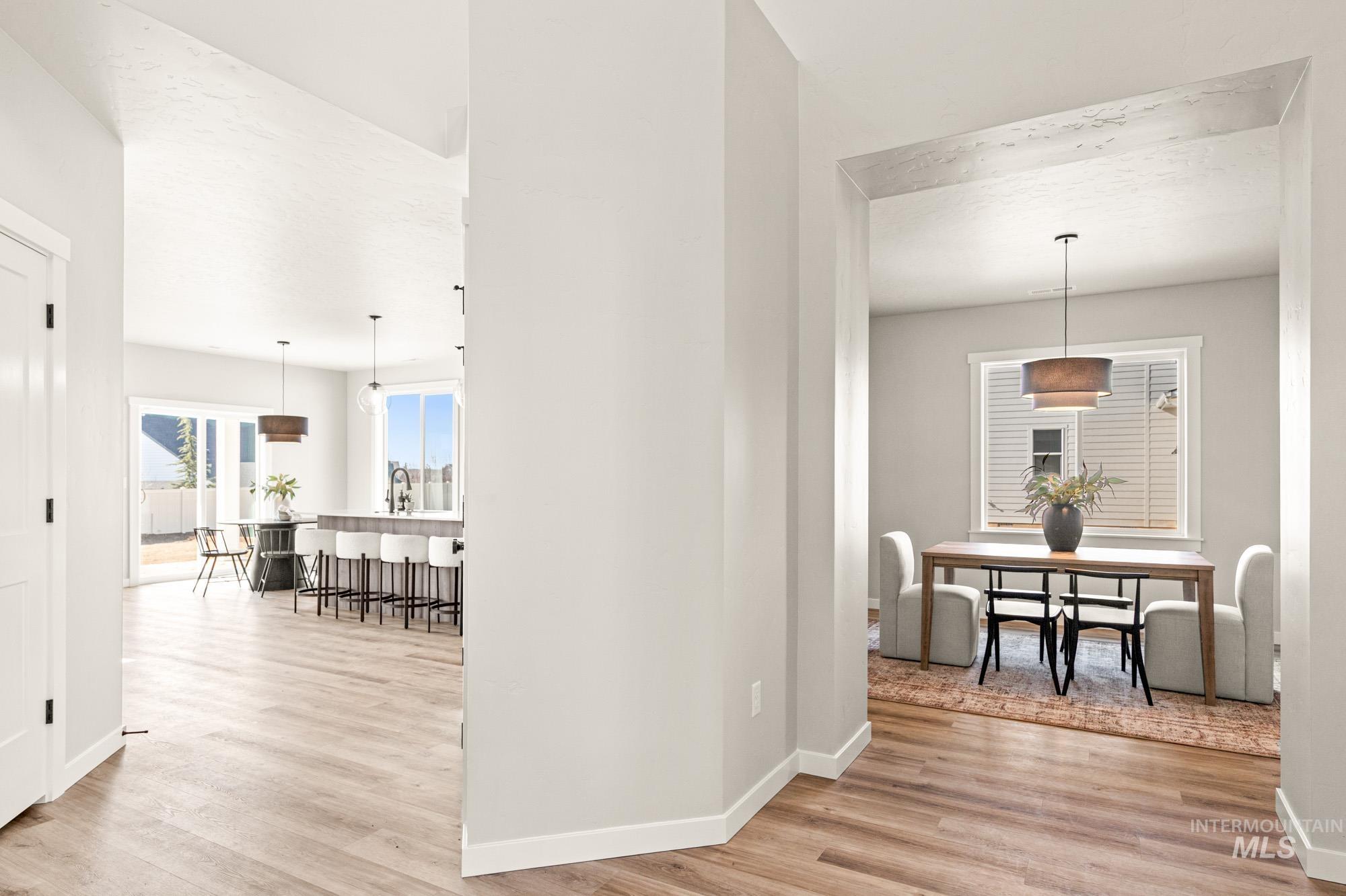 5487 West Yarnell Street Eagle, ID 83616 - Photo 16 of 30 Hallway featuring light wood-type flooring and baseboards