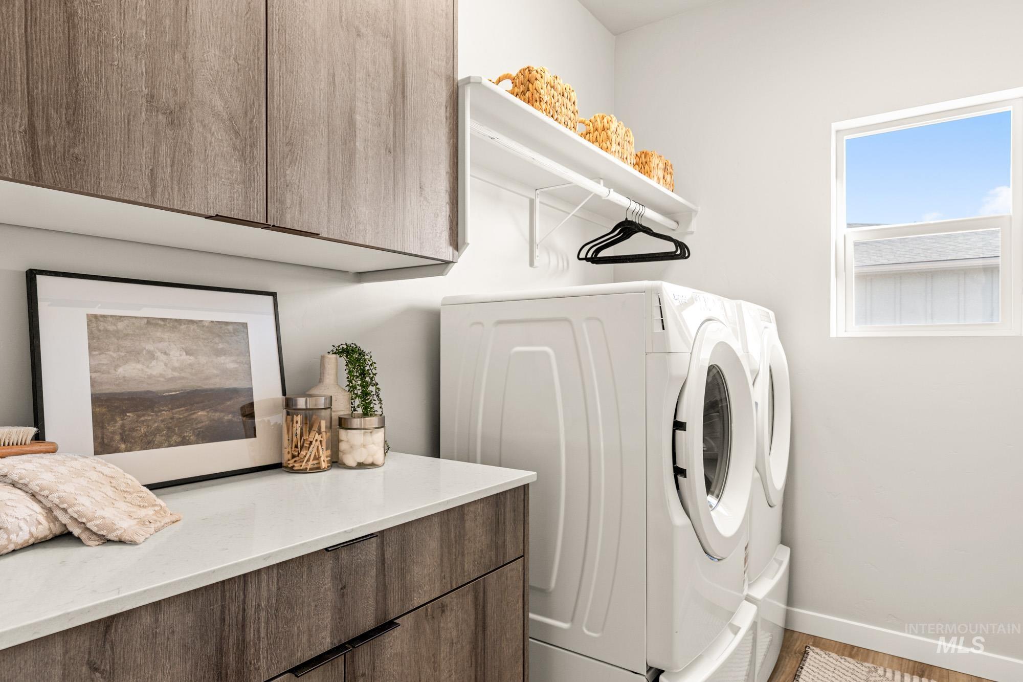 5487 West Yarnell Street Eagle, ID 83616 - Photo 26 of 30 Laundry room with cabinet space and washer and dryer