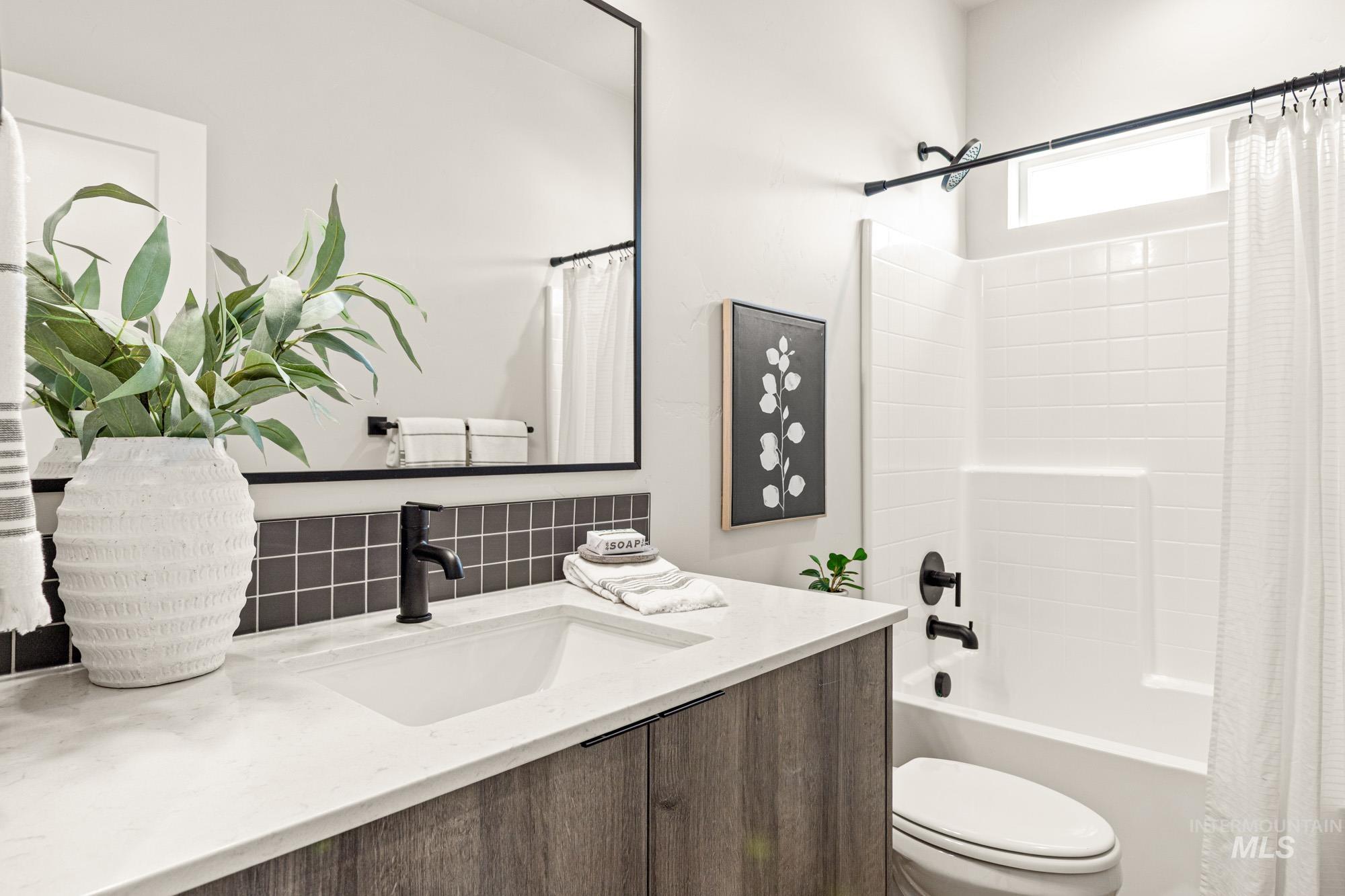 5487 West Yarnell Street Eagle, ID 83616 - Photo 27 of 30 Full bath featuring vanity, shower / tub combo with curtain, and backsplash