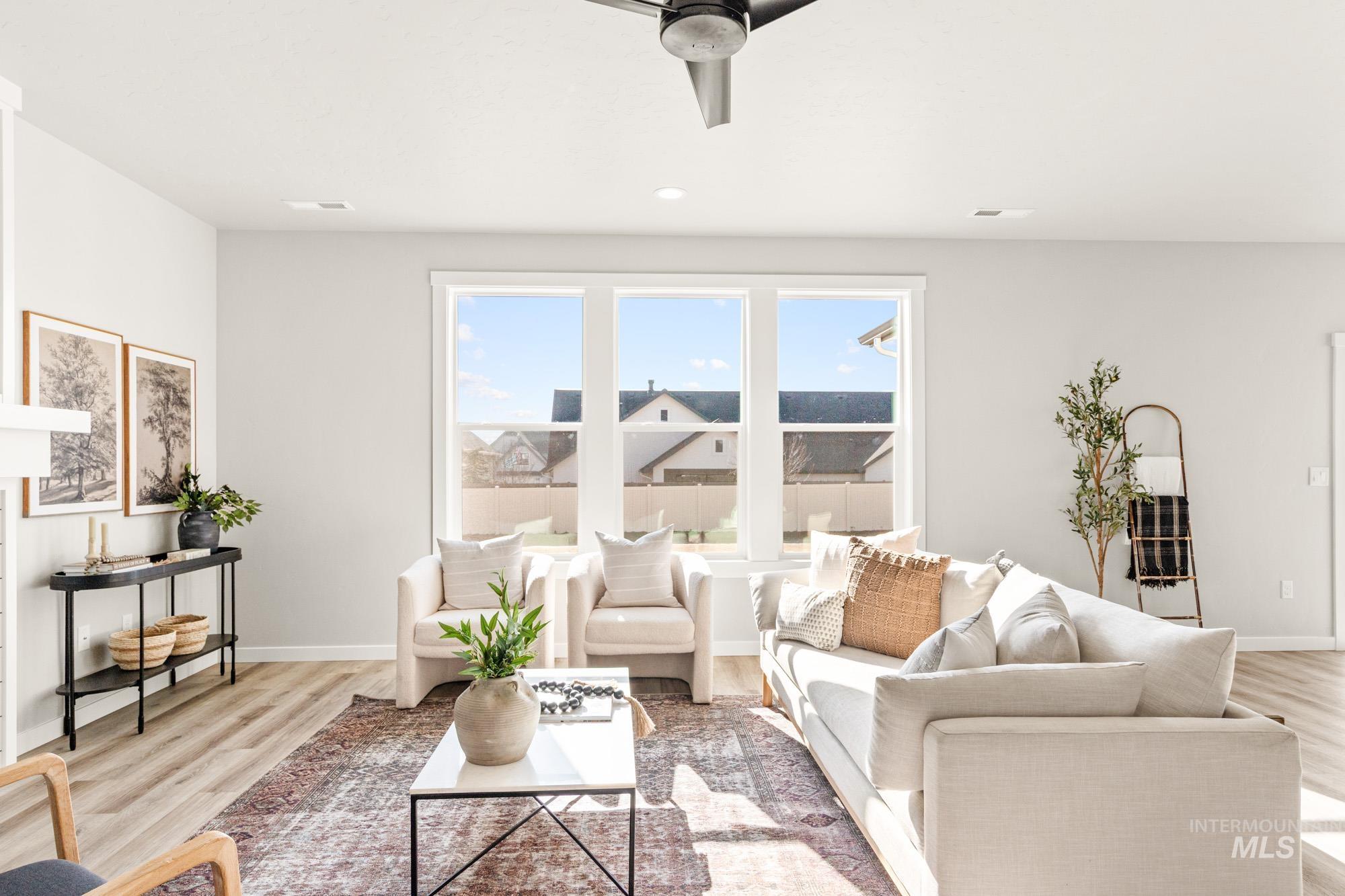 5487 West Yarnell Street Eagle, ID 83616 - Photo 8 of 30 Living room with ceiling fan, light wood-style flooring, and recessed lighting