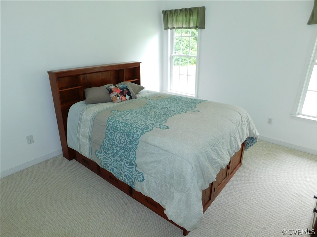 18780 Templeton Road Disputanta, VA 23842 - Photo 24 of 38 a bed sitting in a bedroom next to a window