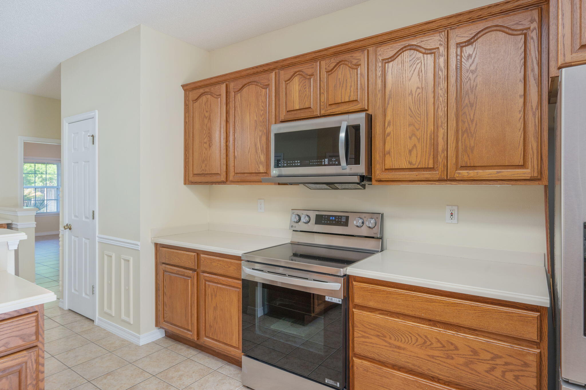 5552 Frontier Drive Crestview, FL 32536 - Photo 19 of 50 a kitchen with stainless steel appliances granite countertop white cabinets and a stove top oven
