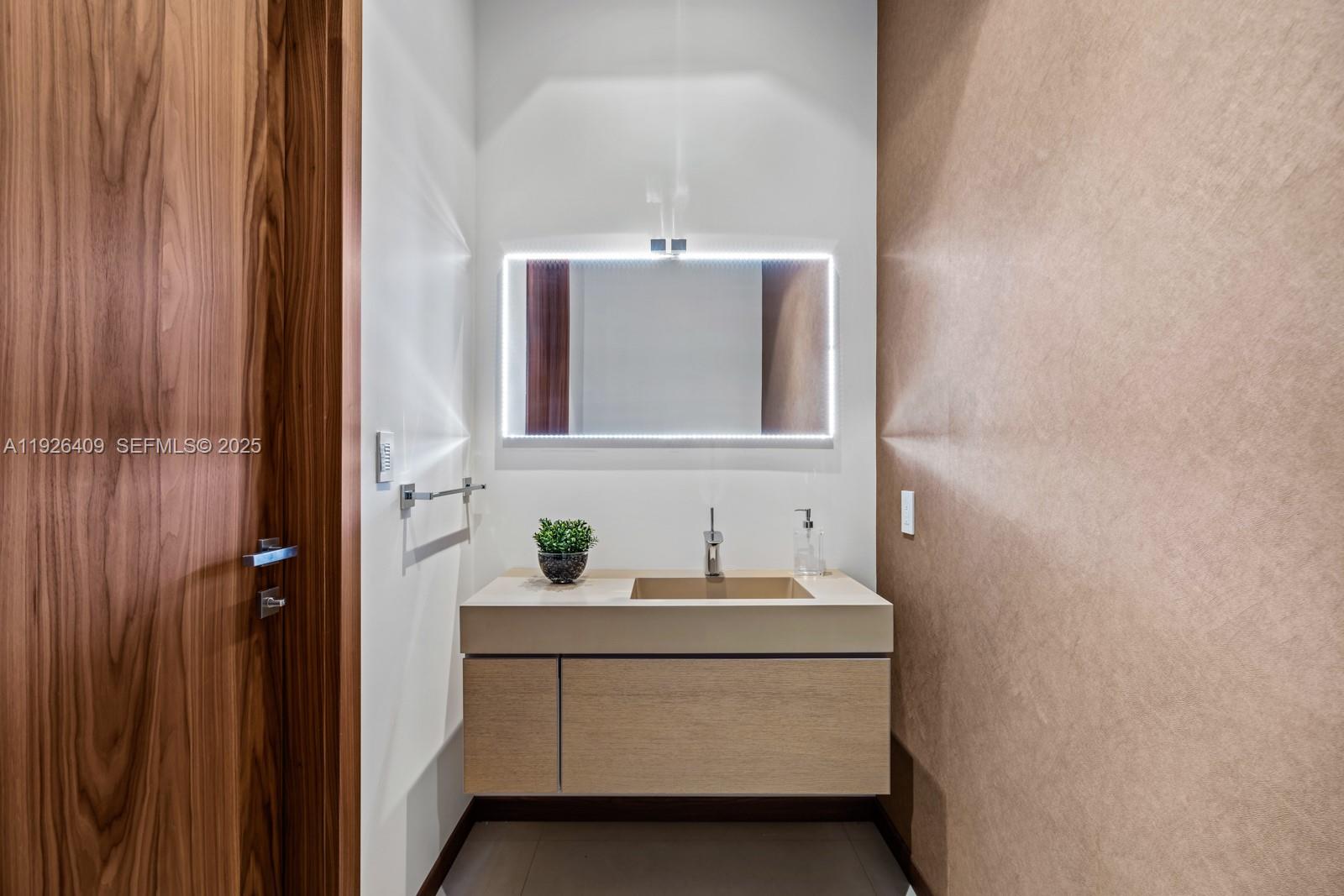 6480 Allison Road Miami Beach, FL 33141 - Photo 26 of 66 a bathroom with a sink and a mirror