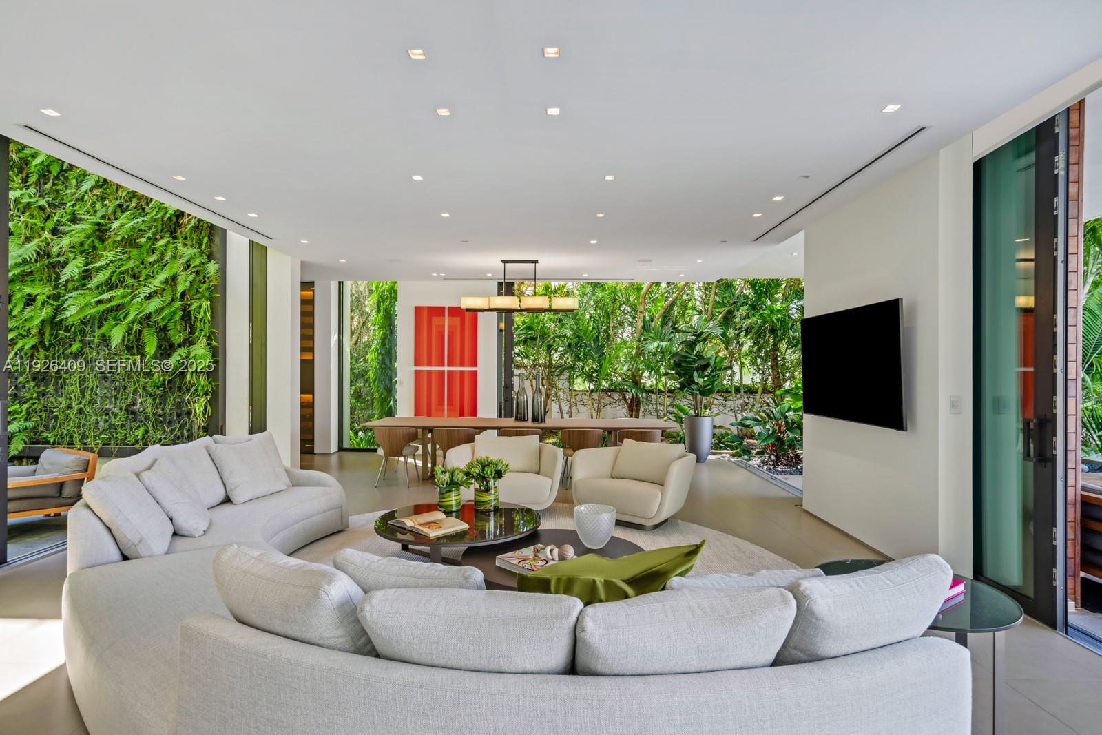 6480 Allison Road Miami Beach, FL 33141 - Photo 30 of 66 a living room with furniture flat screen tv and a large window