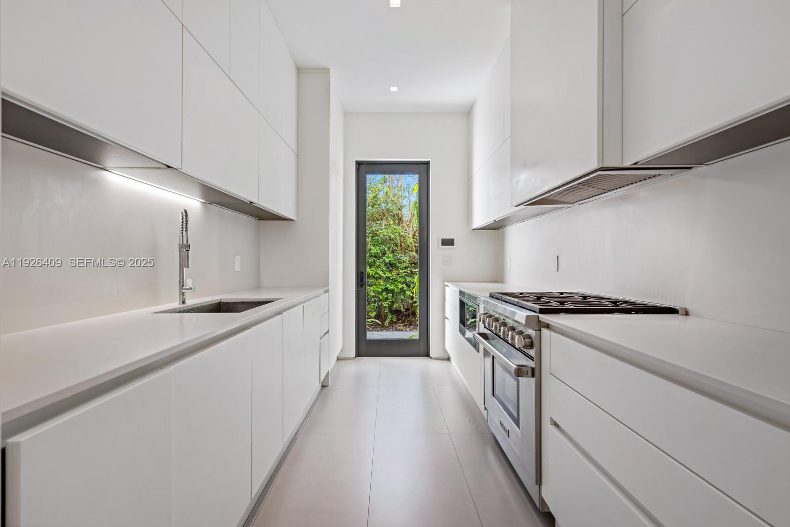 6480 Allison Road Miami Beach, FL 33141 - Photo 37 of 66 a kitchen with granite countertop a sink stove and refrigerator