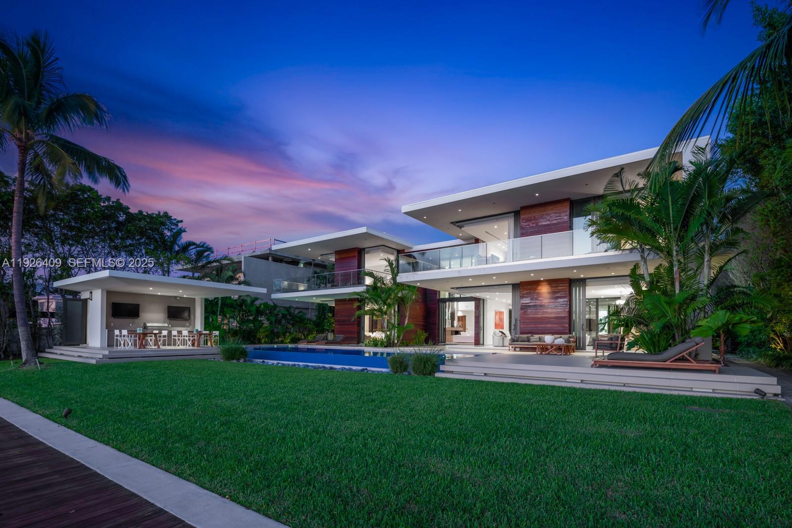 6480 Allison Road Miami Beach, FL 33141 - Photo 43 of 66 a front view of a house with a yard table and chairs