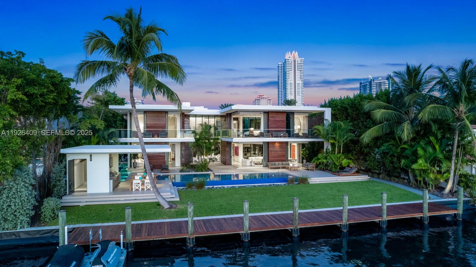 6480 Allison Road Miami Beach, FL 33141 - Photo 46 of 66 a front view of a house with a yard table and chairs