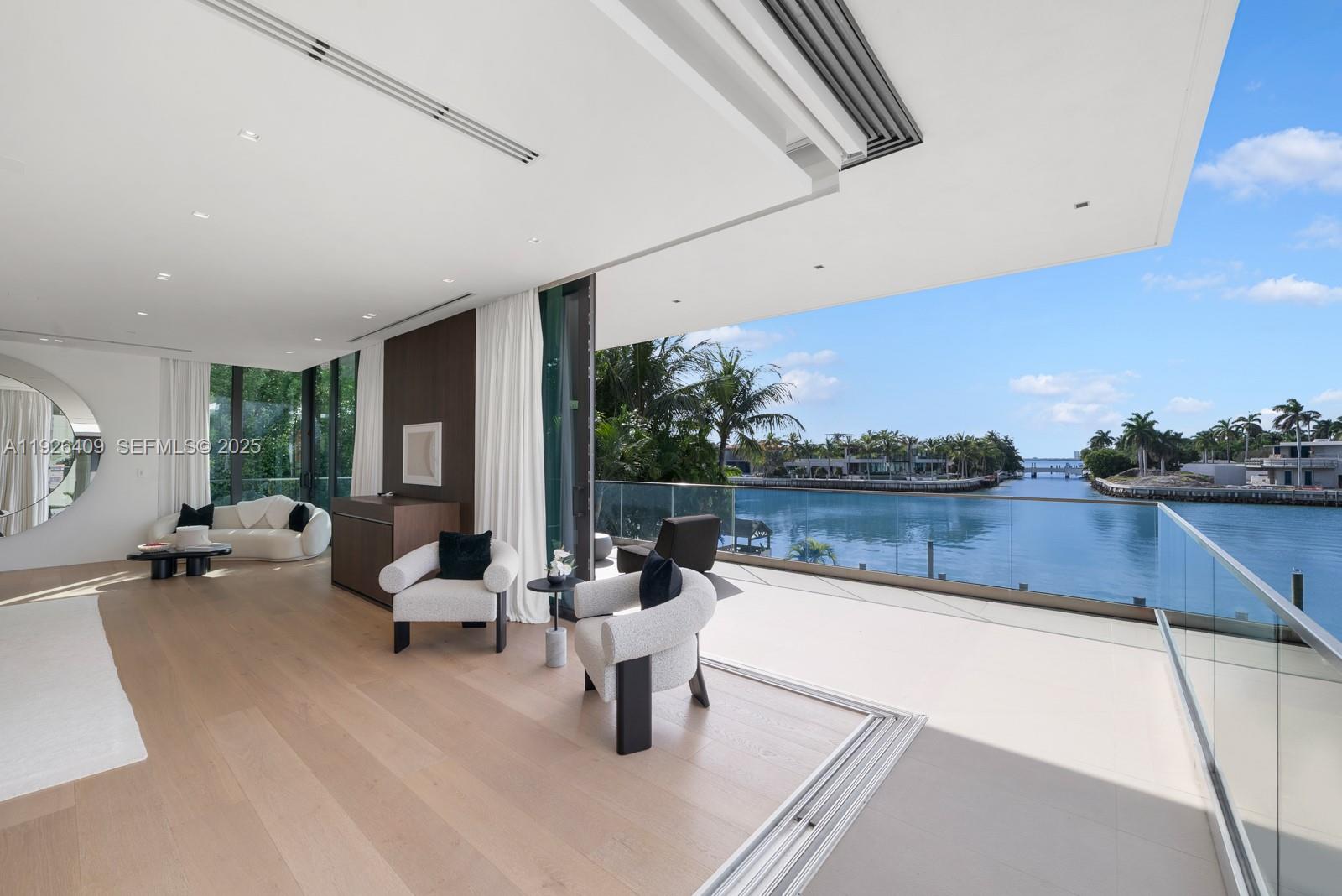 6480 Allison Road Miami Beach, FL 33141 - Photo 53 of 66 a living room with patio furniture and a large window