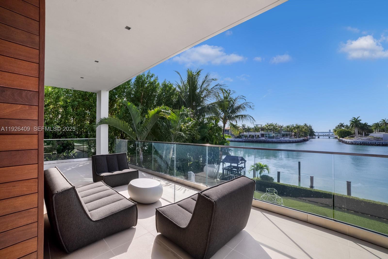 6480 Allison Road Miami Beach, FL 33141 - Photo 54 of 66 a view of a patio with couches table and chairs with potted plants