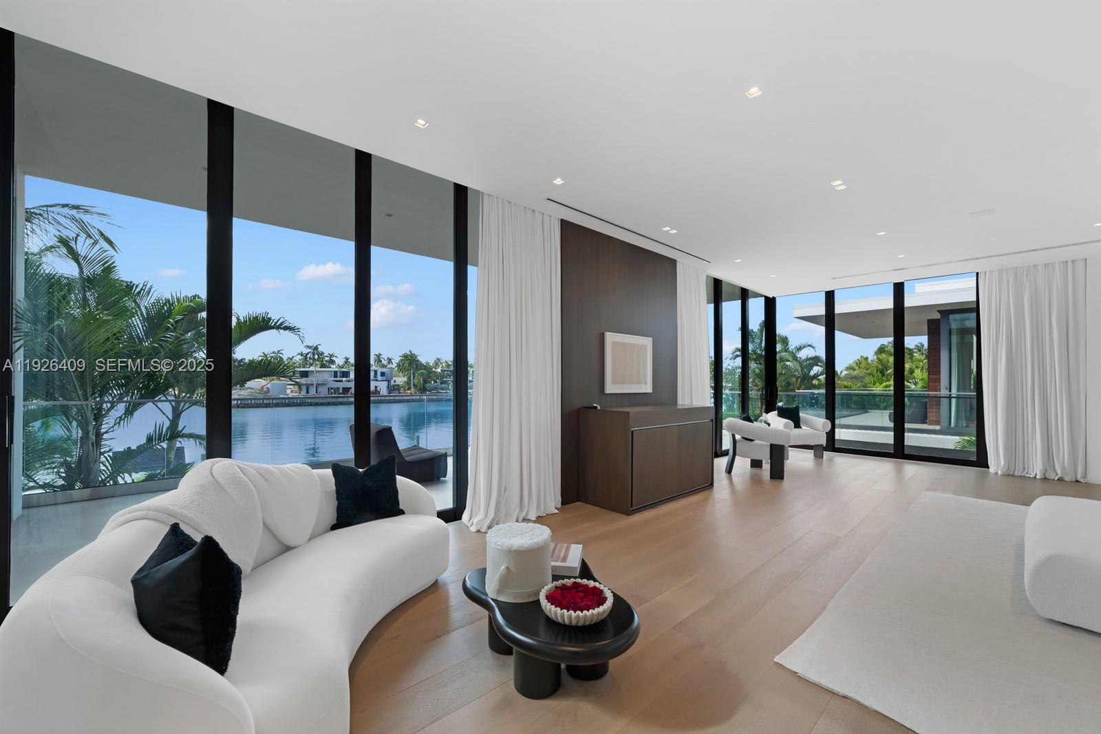 6480 Allison Road Miami Beach, FL 33141 - Photo 59 of 66 a living room with furniture and a floor to ceiling window