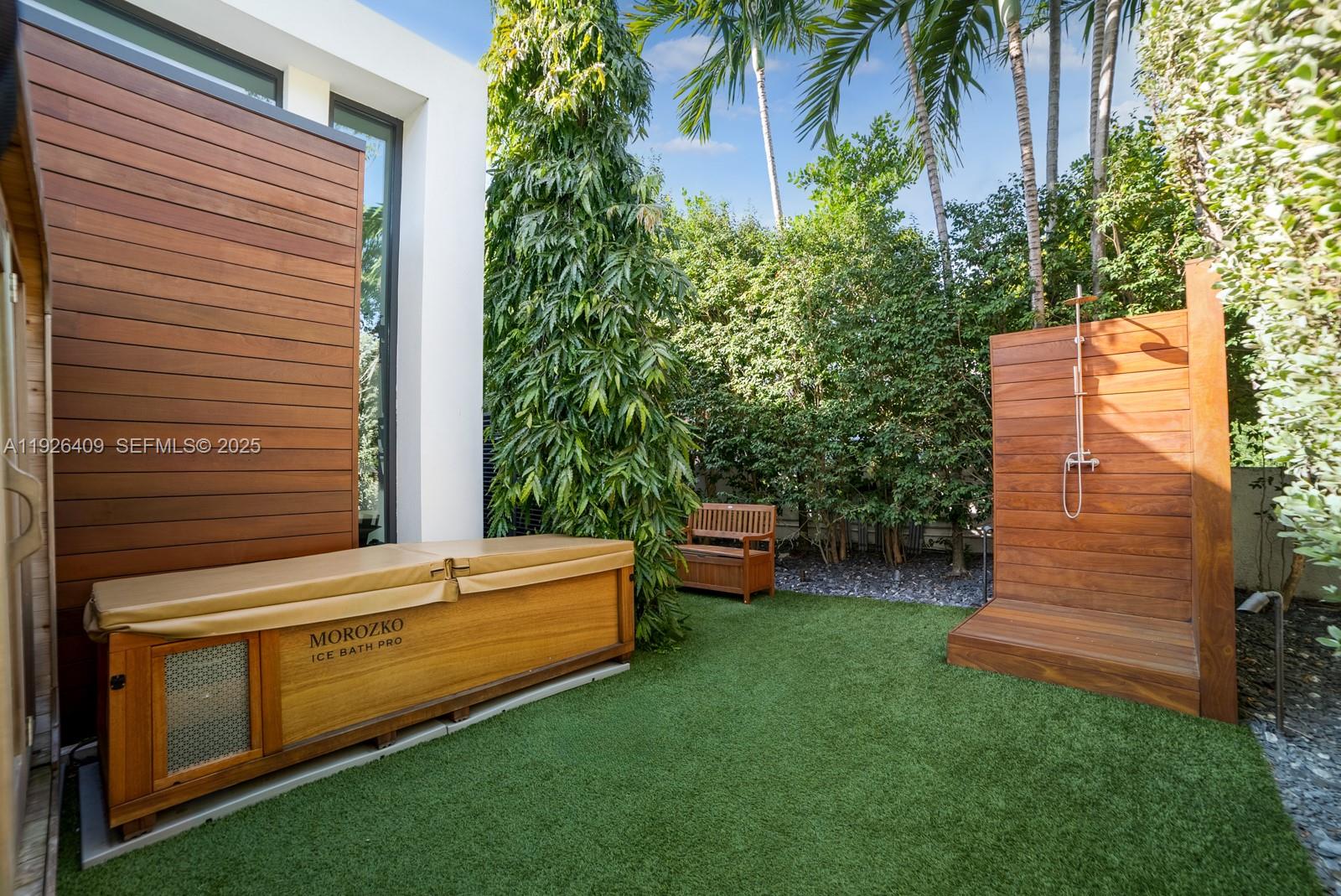 6480 Allison Road Miami Beach, FL 33141 - Photo 66 of 66 a view of a backyard with couches chair and grass