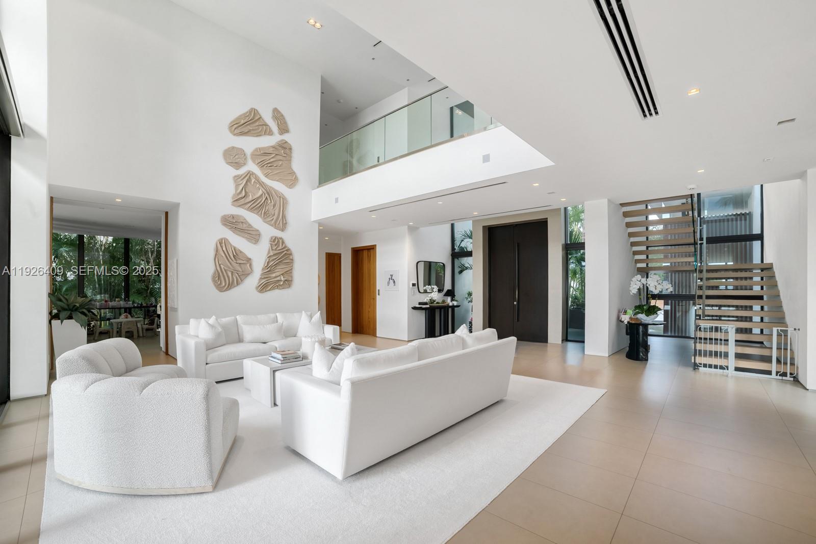 6480 Allison Road Miami Beach, FL 33141 - Photo 9 of 66 a living room with furniture and a large window