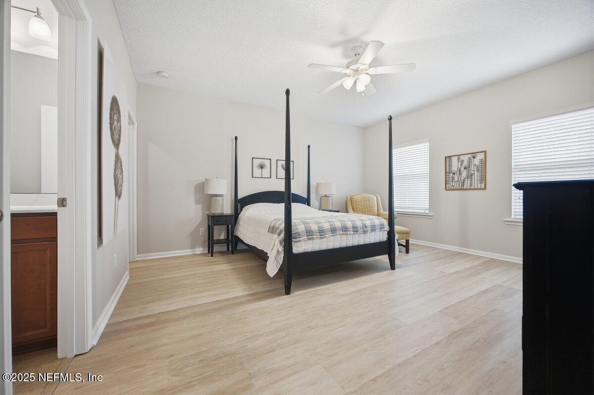 75 Myrtle Park Point Ponte Vedra, FL 32081 - Photo 30 of 38 a bedroom with a bed and a ceiling fan