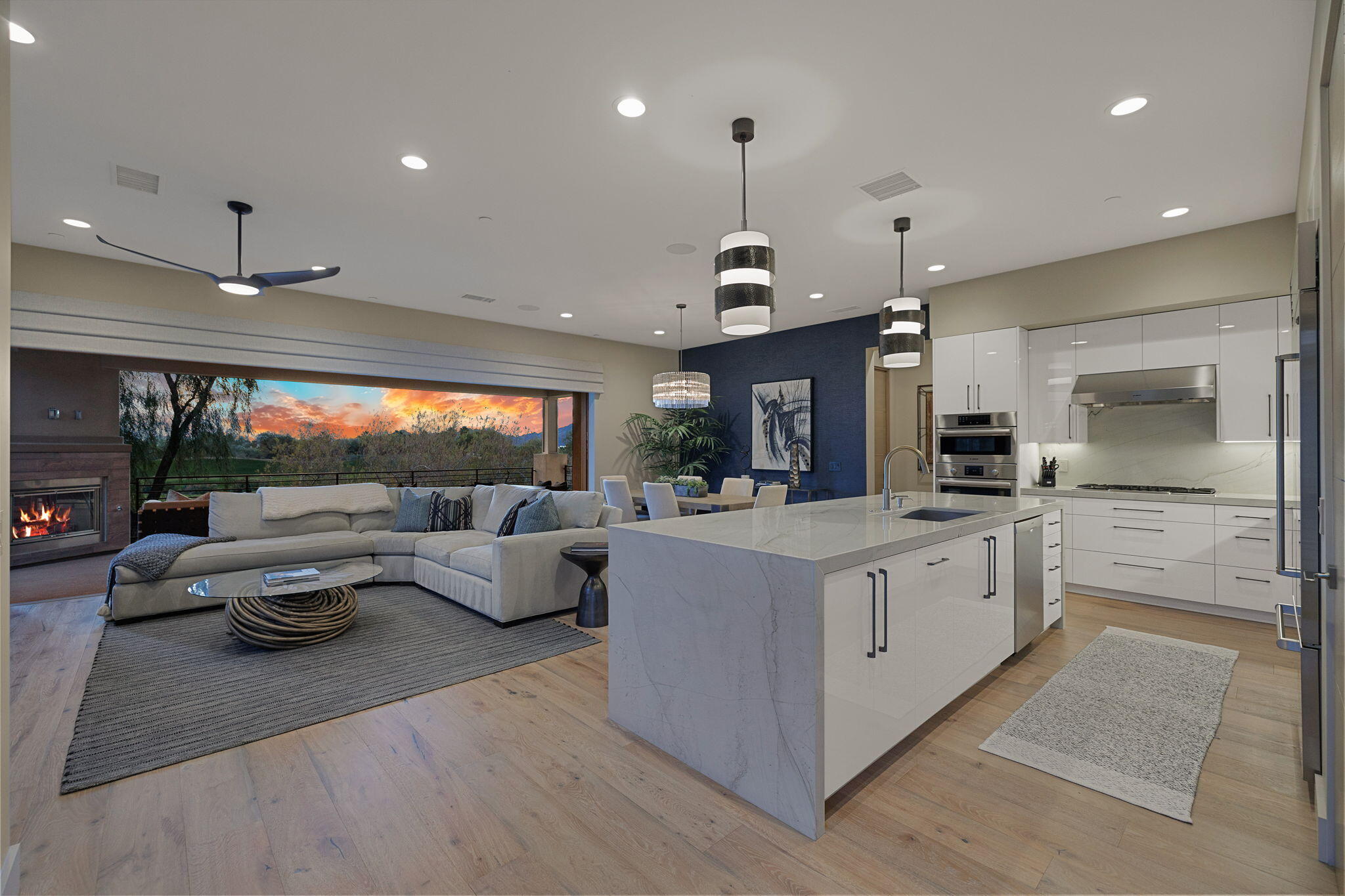 a kitchen with stainless steel appliances granite countertop a lot of living room and couches