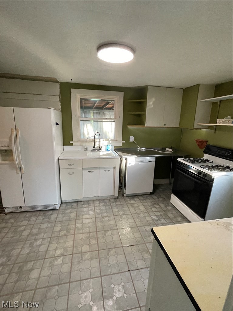 1200 Swartz Road Akron, OH 44306 - Photo 24 of 24 Kitchen featuring sink, light tile flooring, stove, dishwasher, and refrigerator