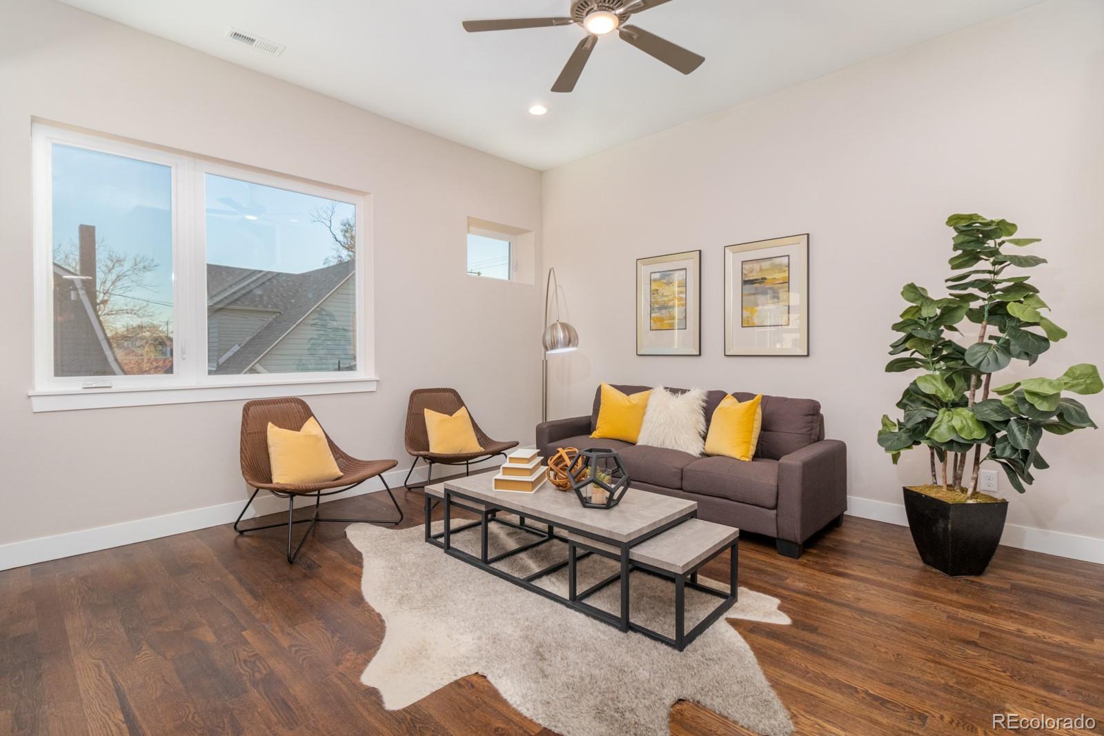 927 Inca Street, Unit 4 Denver, CO 80204 - Photo 3 of 25 a living room with furniture and a potted plant