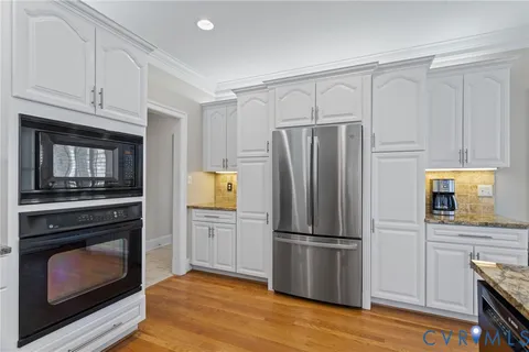 a open kitchen with stainless steel appliances granite countertop a stove and cabinets