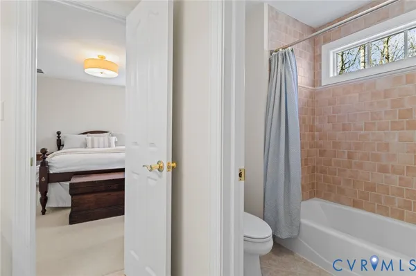 a spacious bedroom with a bed and a chandelier