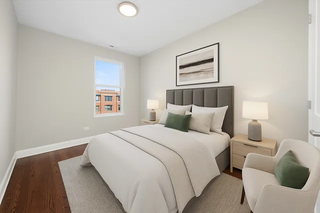 a bedroom with bed and a night stand