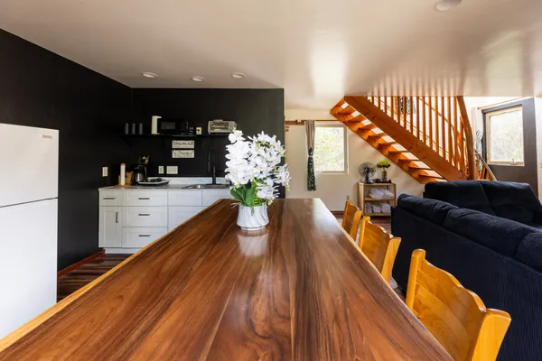 a dining hall with a dining table chairs with wooden floor