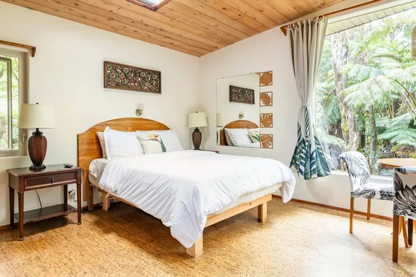 a bedroom with a bed and a chair