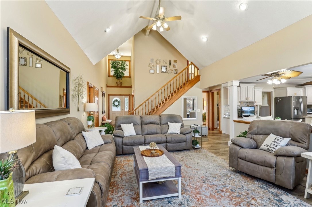 3353 Jens Way Perry, OH 44081 - Photo 3 of 49 Living room with ornate columns, wood-type flooring, high vaulted ceiling, and ceiling fan