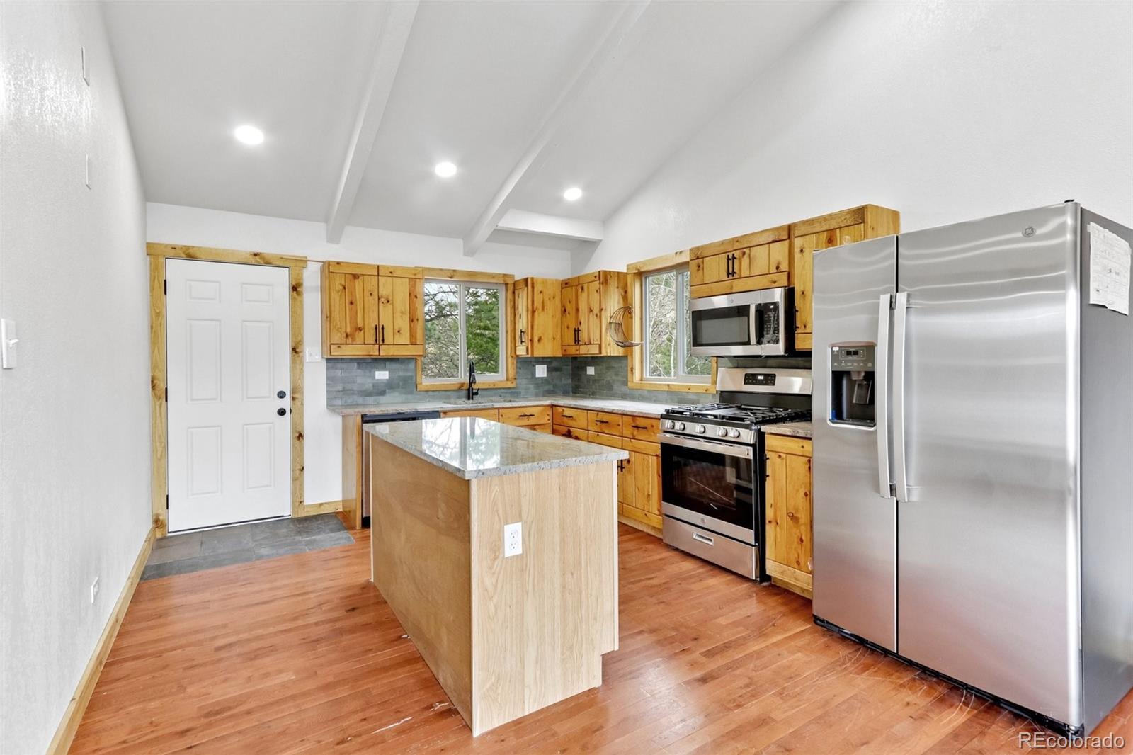 61 Evergreen Road Black Hawk, CO 80422 - Photo 14 of 50 a large kitchen with stainless steel appliances granite countertop a refrigerator a stove top oven a sink and dishwasher