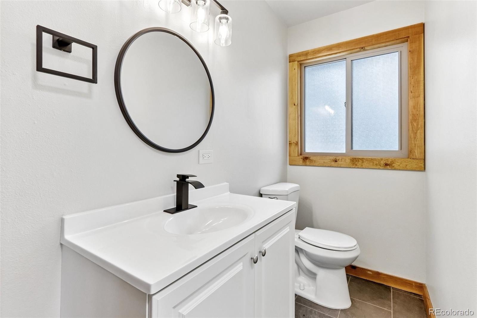 61 Evergreen Road Black Hawk, CO 80422 - Photo 21 of 50 a bathroom with a toilet sink and mirror