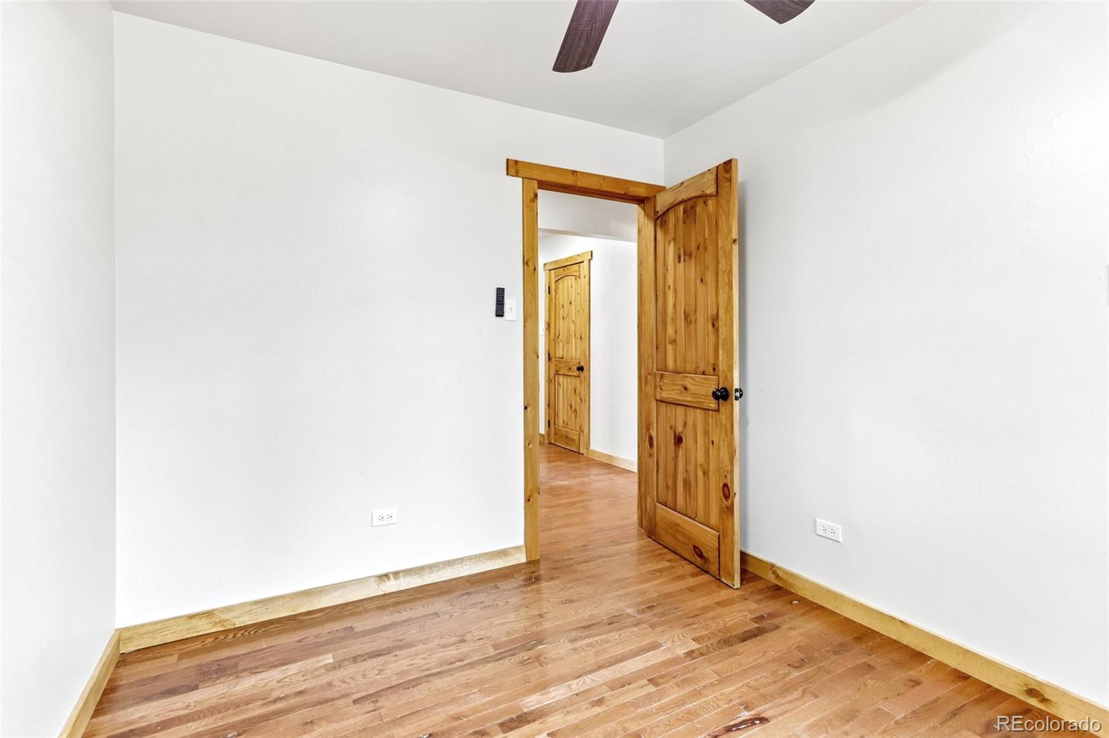61 Evergreen Road Black Hawk, CO 80422 - Photo 23 of 50 a view of an empty room with wooden floor and a window