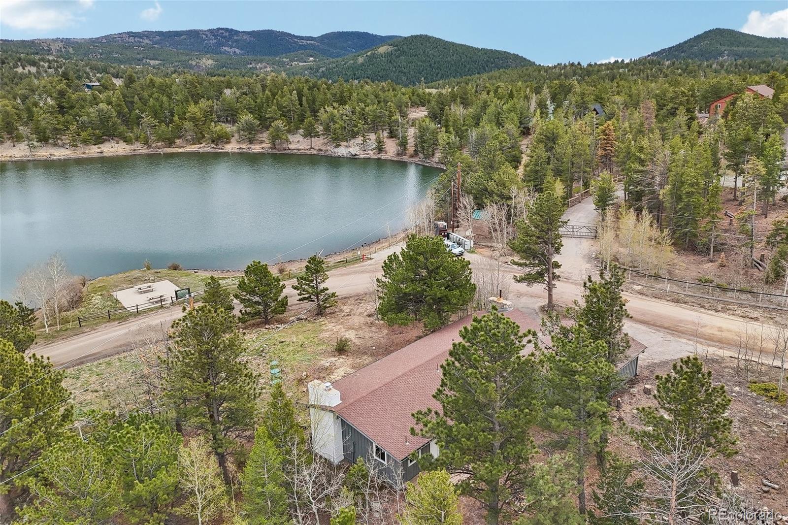 61 Evergreen Road Black Hawk, CO 80422 - Photo 3 of 50 an aerial view of a house with a lake view
